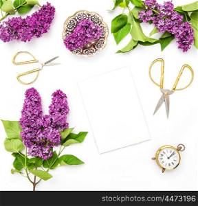 Lilac flowers, sketchbook, office supplies. Flat lay background top view