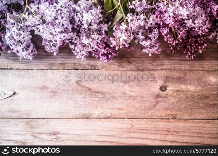 Lilacs on wooden backgorund