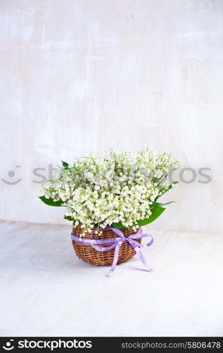 Lily of the valley on white wooden background