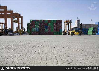 Limassol, Cyprus, Mobile crane moving containers in stockyard