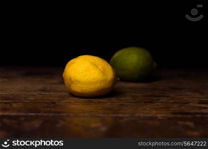 Lime and lemon on wooden surface