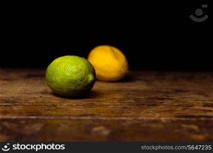 Lime and lemon on wooden surface