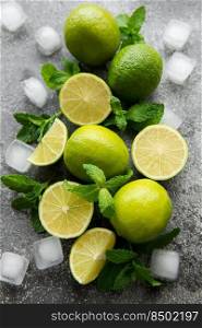 Lime and mint on a dark background. The ingredients for making refreshing drinks and cocktails.