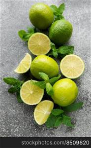 Lime and mint on a dark background. The ingredients for making refreshing drinks and cocktails.
