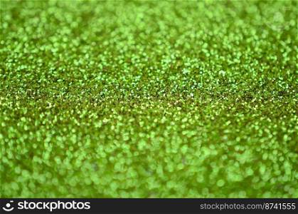 Lime green decorative sequins. Background image with shiny bokeh lights from small elements that reflect light. Lime green decorative sequins. Background image with shiny bokeh lights from small elements