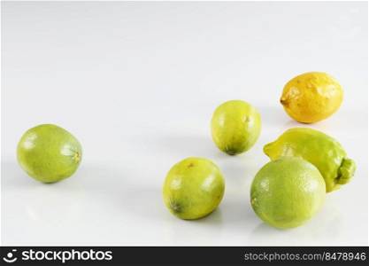 limes and lemons on white background. Citrys fruits as a background