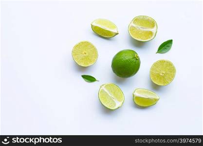 Limes on white background. Copy space