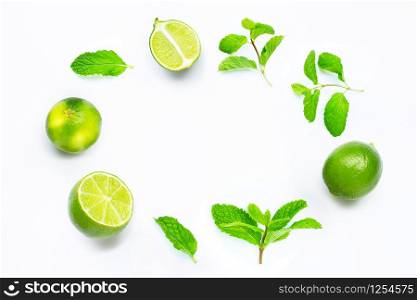 Limes with mint leaves isolated on white background. Copy space