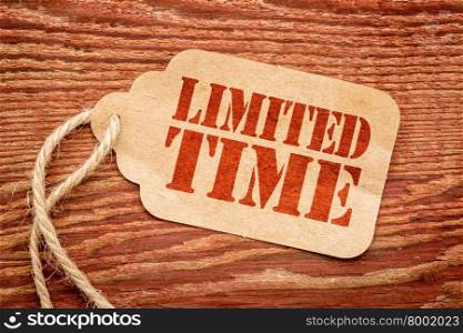 limited time offer sign - red stencil text on a paper price tag against rustic wood