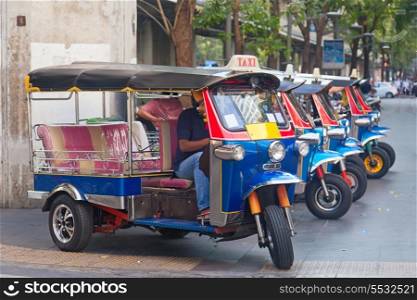 Line of tuktuks with driver on Bangkok street, Thailand&#xA;