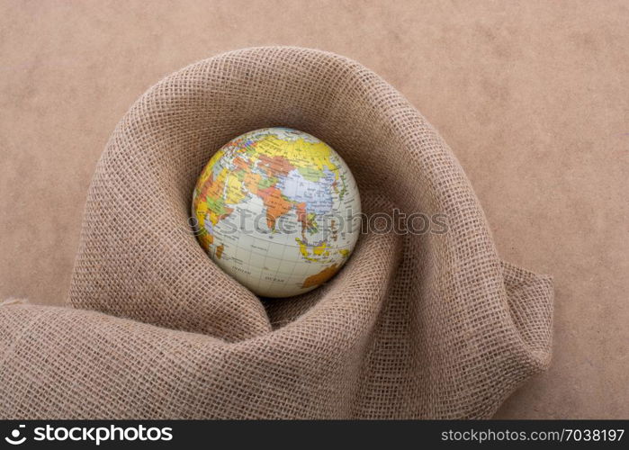 Linen canvas is wrapped around a model globe