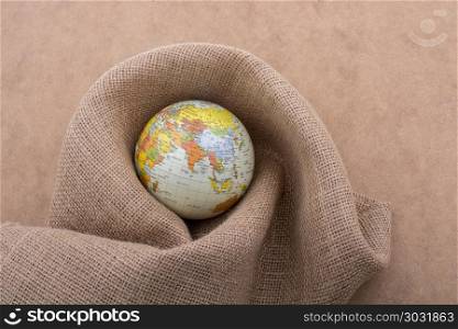 Linen canvas wrapped around a globe. Linen canvas is wrapped around a model globe