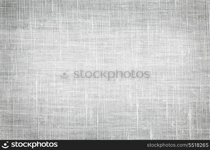 Linen fabric background. White linen woven fabric background or texture with dark vignette