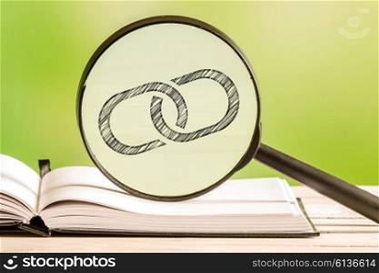 Link information with a pencil drawing of a chain link in a magnifying glass