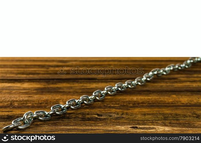 links of the steel chromeplated chain on wooden background