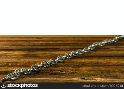 links of the steel chromeplated chain on wooden background