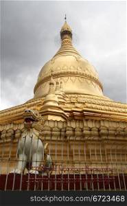Lion and golden stupa in Ne Vin pagoda, Yangon, Myanmar