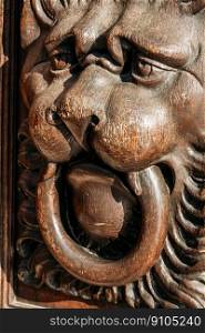 Lion head wood carving on old wooden door. Decorate detail. Lion head wood carving on wooden door