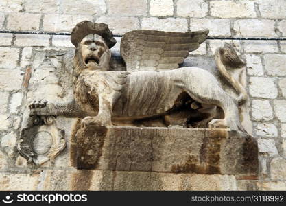 Lion with wings on the wall of tower in Croatia