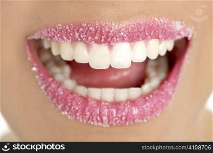 Lips of a woman in sugar pink liptstick makeup macro