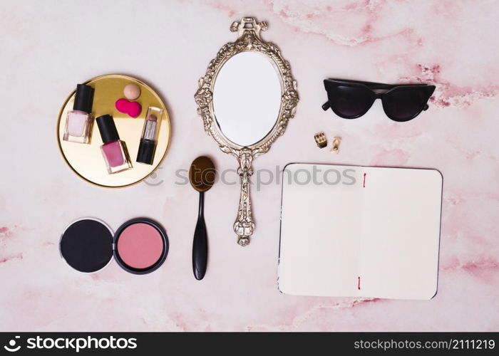 lipstick nail polish bottles compact face powder makeup brush hand mirror clutcher open blank diary pink backdrop