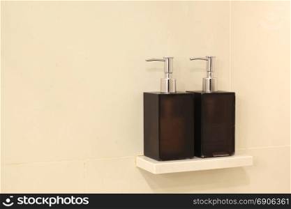 liquid soap bottle and shampoo dispenser in bathroom