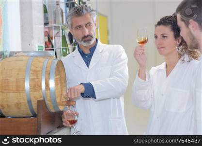 liquor maker shows to experts a glass of armagnac