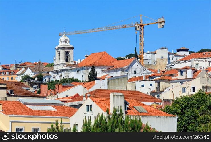 Lisbon cityscape summer view with bell tower and building crane, Portugal. All people are unrecognized.