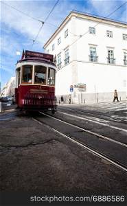 LISBON, PORTUGAL - FEBRUARY 3, 2016: Traditional tourist tram at old streets, Lisbon old city, Portugal