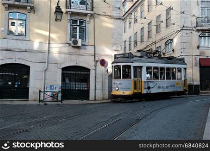 LISBON, PORTUGAL - MAY 3, 2017: Traditional yellow tram at old streets, Lisbon old city, Portugal