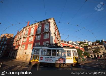 LISBON, PORTUGAL - MAY 3, 2017: Traditional yellow tram running at the old streets of Lisbon, Portugal