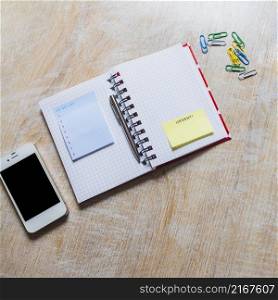 list notepad urgent sticky note checkered notebook with smartphone paperclip