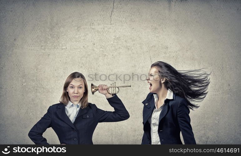 Listen everyone. Young businesswoman in suit proclaiming something in horn