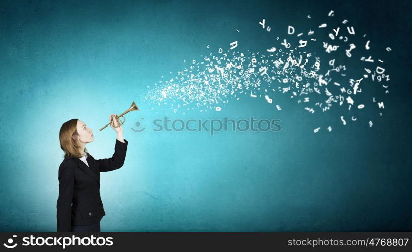 Listen everyone. Young businesswoman in suit proclaiming something in horn