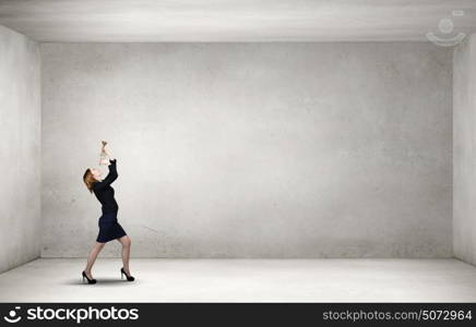 Listen everyone. Young businesswoman in suit proclaiming something in horn