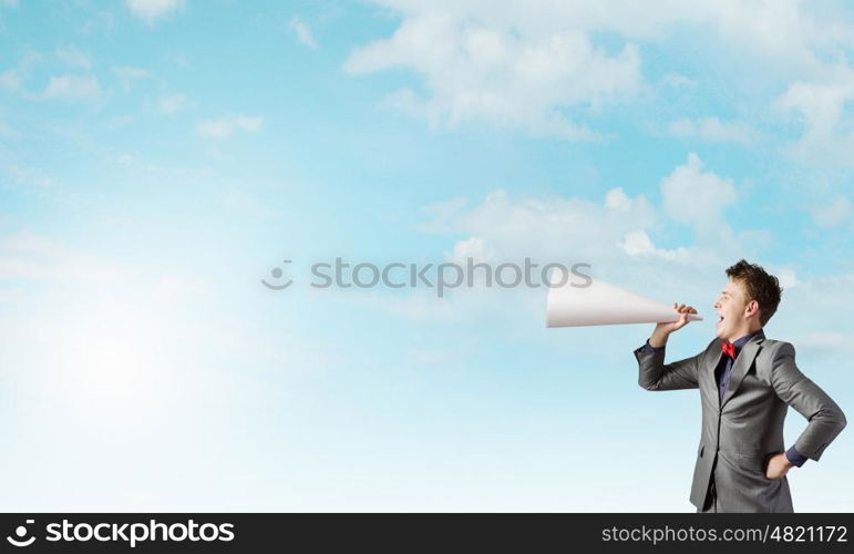 Listen everyone. Young man making some announcement in trumpet