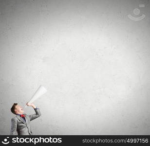 Listen everyone. Young man making some announcement in trumpet