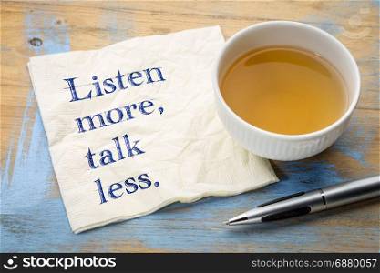 Listen more, talk less - motivational text on a napkin with a cup of tea