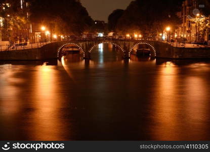 Lit bridge in Amsterdam at night