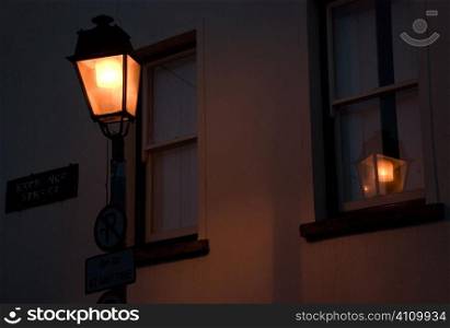 Lit street lamp and window in Exchange Street, County Cork, Ireland