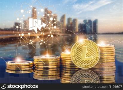 Litecoin LTC and cryptocurrency investing concept - Physical Litecoin coins with city background and exchange market trading price chart. Blockchain and financial technology.. Litecoin LTC and Cryptocurrency Trading Concept