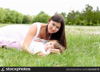 litlle girl with her mother outdoors on the grass