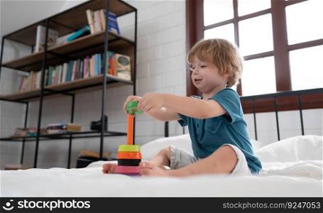 Litt≤boy in his bedroom with a≠w toy purchased by his parents to help him improve his thinking skills.