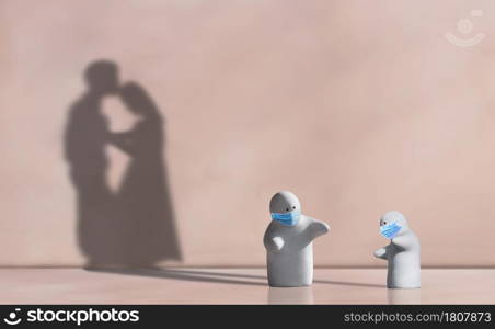 Little 2 garden dolls wearing protective mask in distancing concern gesture with shadow of couple contiguous encouraging on pink wall background, Metaphorical concept of adaptive lifestyle in COVID-19