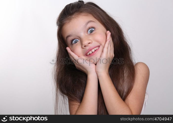 little amazing girl with blue eyes and opening mouth isolated on white