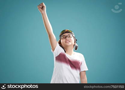 Little asian boy wear aviator glasses enjoy her travel and adventure dreams , isolated on light blue background .