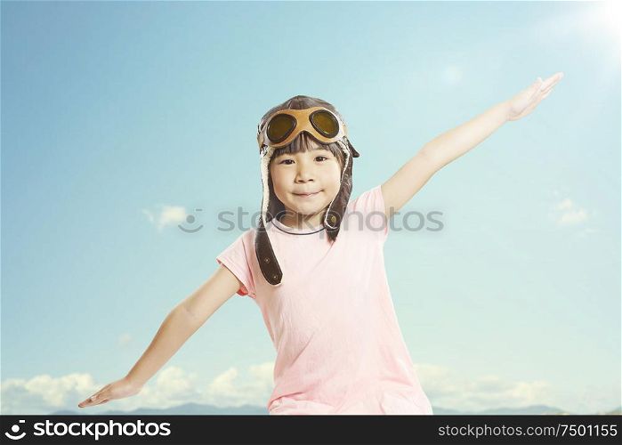 Little asian girl wear aviator glasses and enjoy her travel dreams , summer sky background .