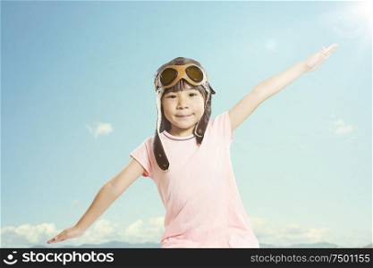 Little asian girl wear aviator glasses and enjoy her travel dreams , summer sky background .