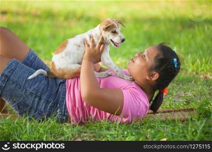 little asian girls and puppy in the garden
