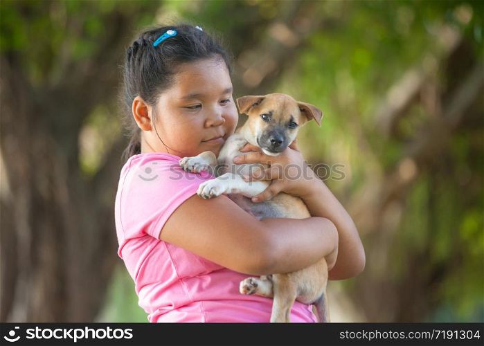 little asian girls and puppy in the garden